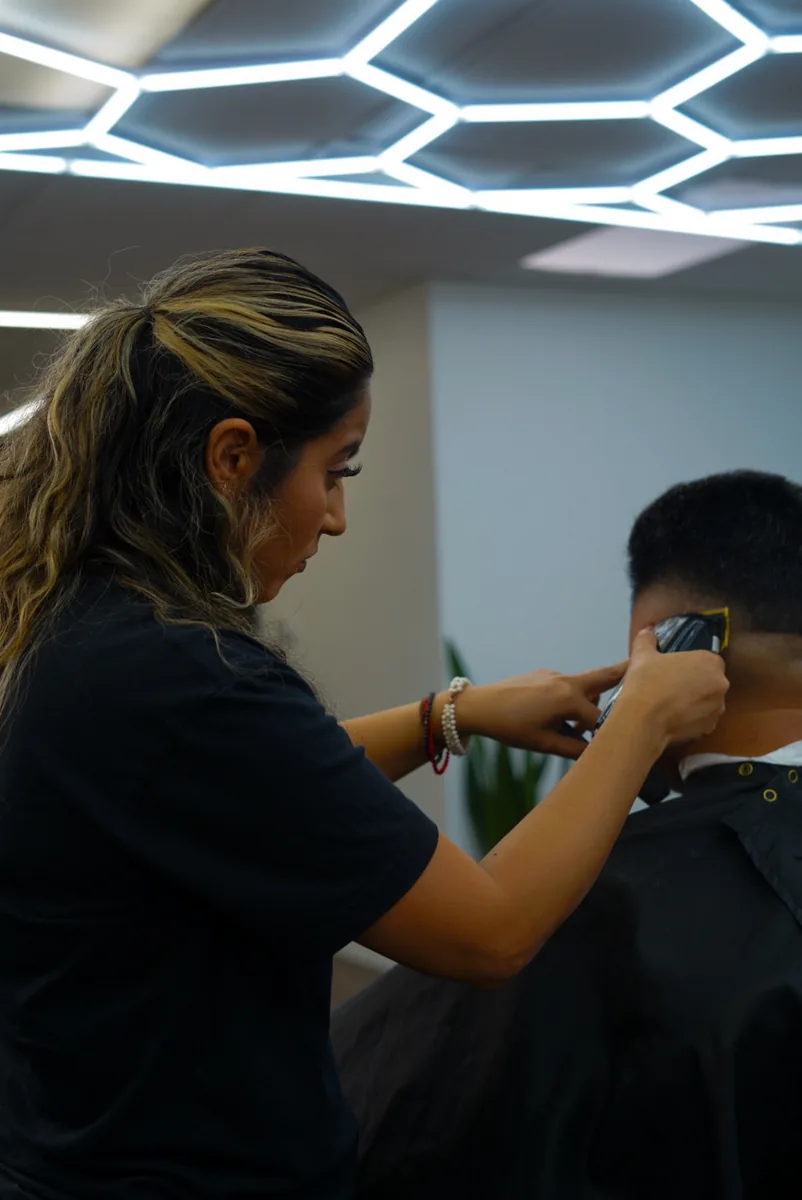 Barber clipping a fresh fade at the nape