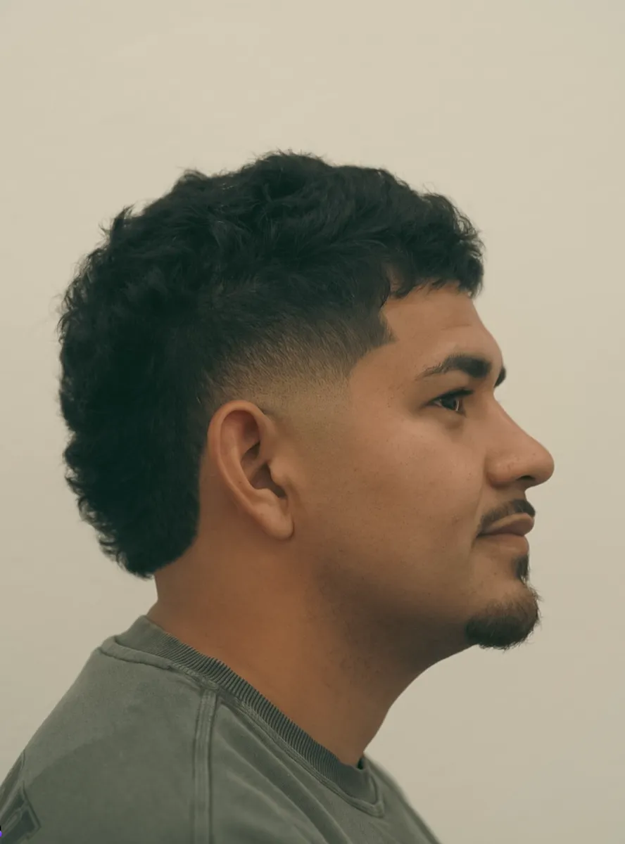 Curly low fade side profile